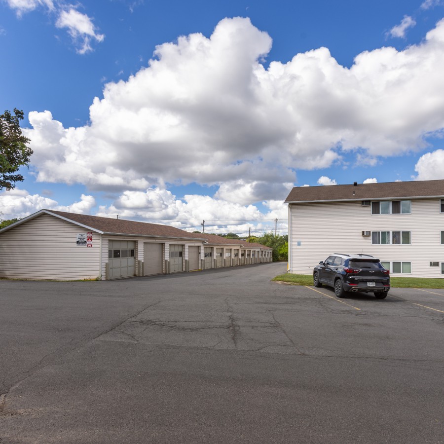 Garages and an apartment building across the lot at Brook Manor Apartments, Syracuse NY