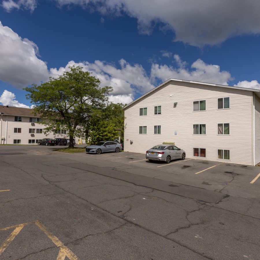 Three-story building and parking lot at Brook Manor Apartments, Syracuse NY